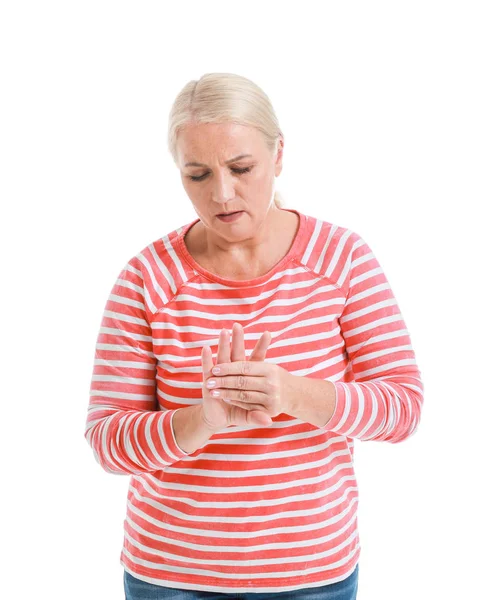 Mature woman suffering from pain in wrist on white background — Stock Photo, Image