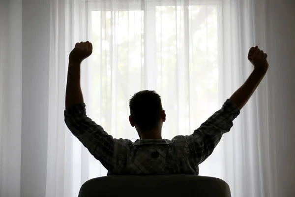 Silhouette of man relaxing at home, back view — Stock Photo, Image