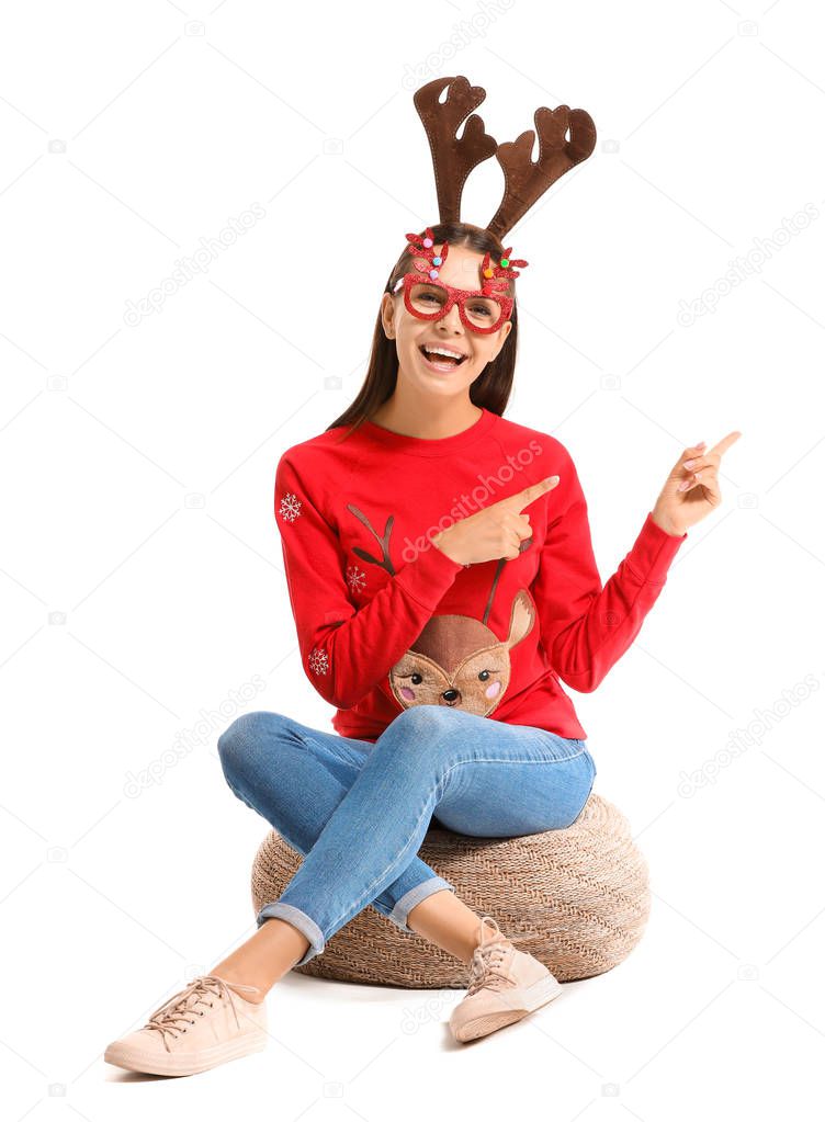 Funny young woman in Christmas sweater on white background
