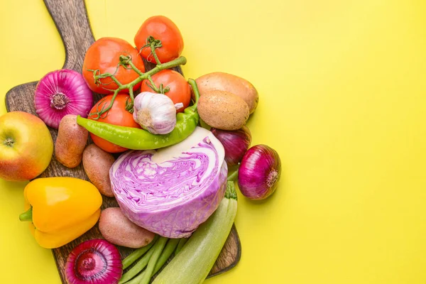 Board with many healthy vegetables on color background — Stock Photo, Image