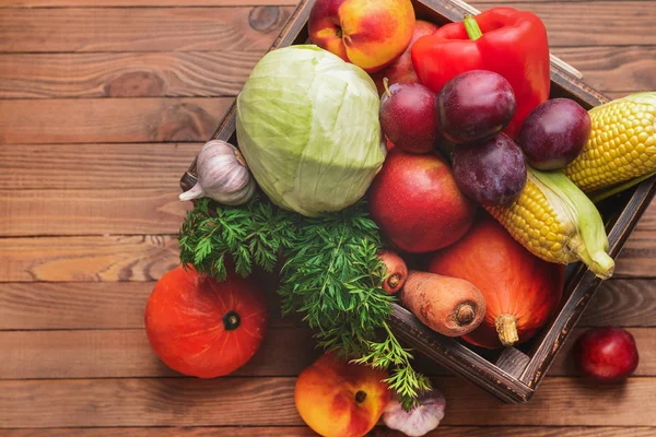 Box with many healthy vegetables and fruits on wooden background — Stock Photo, Image