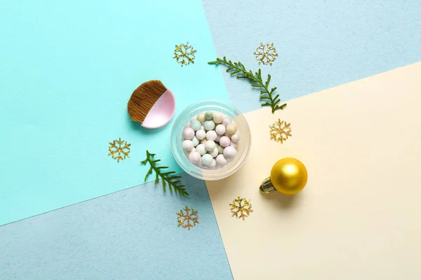 Powder pearls with brush and Christmas decor on color background — Stock Photo, Image