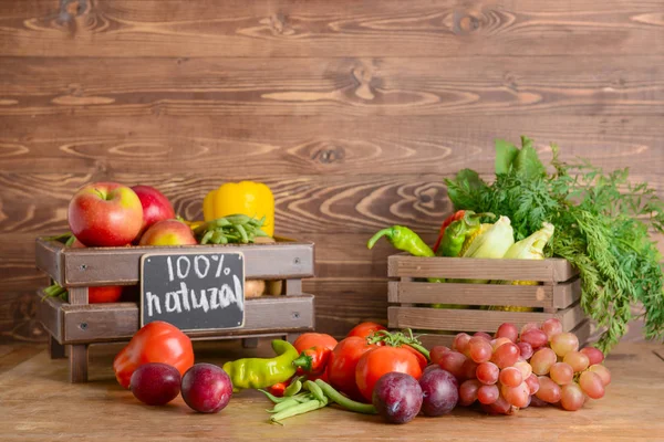 Many healthy vegetables and fruits on wooden table — Stock Photo, Image