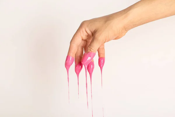 Female hand in sugaring paste on light background