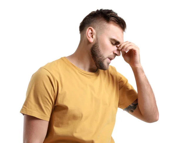 Young man suffering from headache on white background — Stock Photo, Image