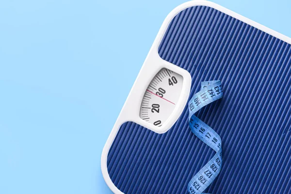 Scales and measuring tape on color background. Weight loss concept — 스톡 사진