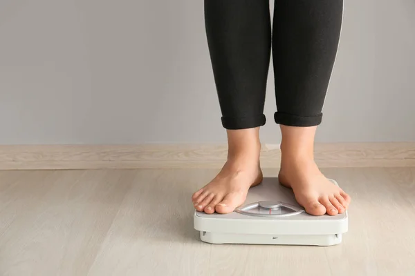 Woman standing on scales. Weight loss concept — 스톡 사진