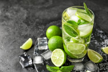 Koyu arkaplanda bir bardak taze mojito.