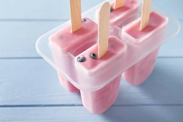 Tasty blueberry ice cream on wooden table — Stock Photo, Image