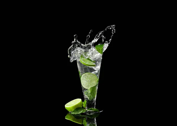 Glass of fresh mojito with splashes on dark background — Stock Photo, Image