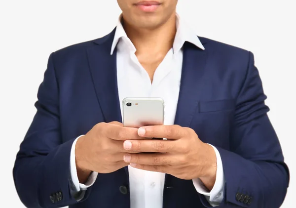 Afro-Amerikaanse zakenman met mobiele telefoon op witte achtergrond, close-up — Stockfoto