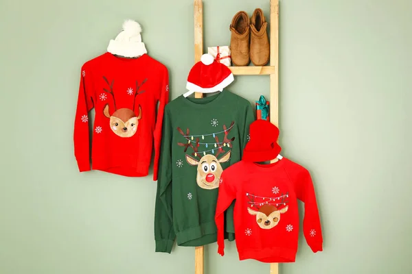 Set of family Christmas clothes on color background — Stock Photo, Image