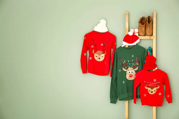 Set of family Christmas clothes on color background — Stock Photo, Image