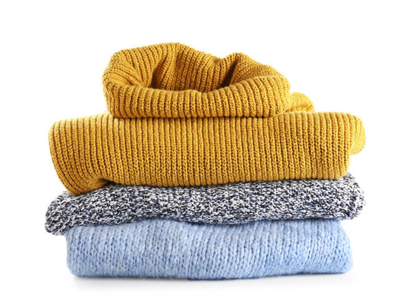 Warm winter clothes on white background