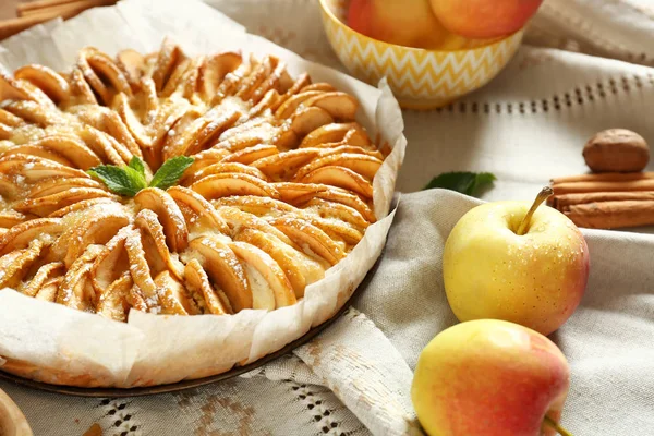 Sweet apple pie on table