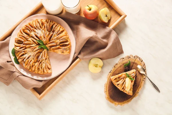 Composition with sweet apple pie on table