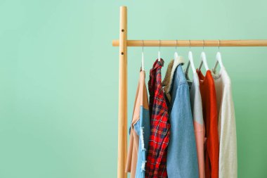 Renkli arka planda asılı giysiler ile Raf