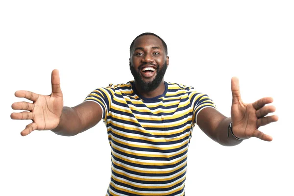 Happy African-American man showing something on white background — Stock Photo, Image