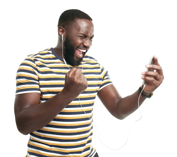 Happy African-American man listening to music on white background — Stock Photo, Image