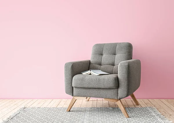 Comfortable armchair near color wall — Stock Photo, Image