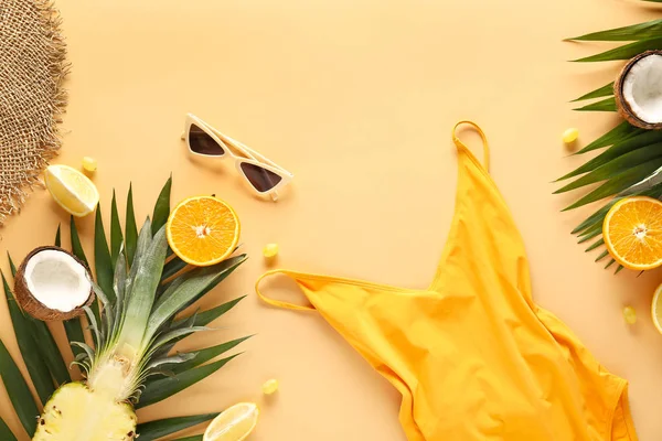 Summer composition with swimming suit, fruits and sunglasses on color background — Stock Photo, Image