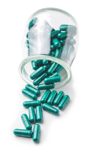 Felborult üveg üveg spirulina tabletták fehér alapon — Stock Fotó