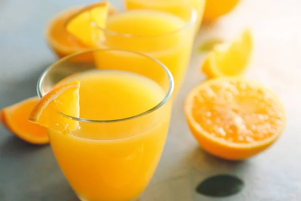 Glasses of fresh orange juice on table, closeup — Stock Photo, Image