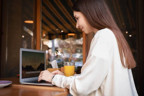 Female travel blogger working on laptop in cafe — Stock Photo, Image