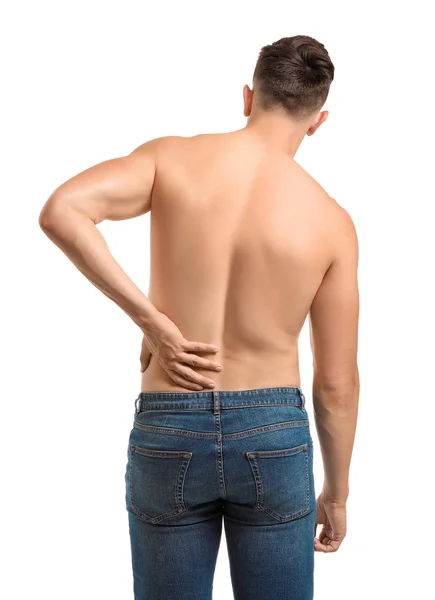 Young man suffering from back pain on white background — Stock Photo, Image