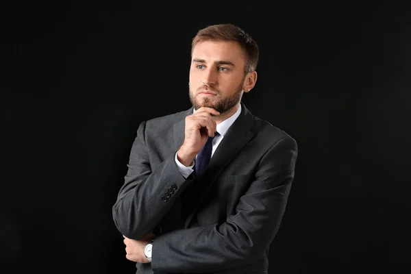 Portrait of handsome businessman on dark background — Stock Photo, Image