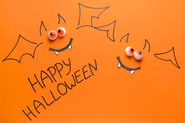 Drawn bats with written text HAPPY HALLOWEEN on color background — Stock Photo, Image