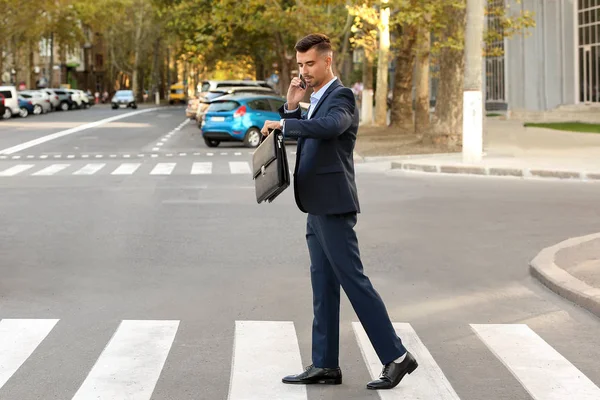 Handsome businessman on pedestrian crosswalk — Stock Photo, Image