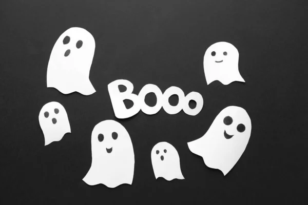 Paper ghosts as decor for Halloween party on black background — Stock Photo, Image