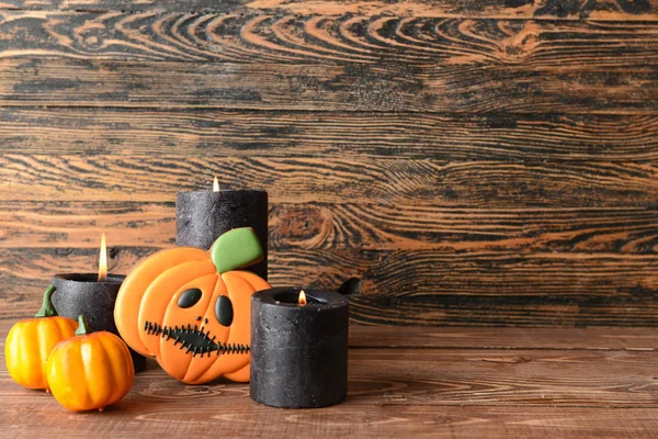 Creative Halloween cookie and candles on wooden background — Stock Photo, Image
