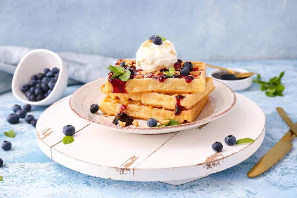Plate with tasty waffles, ice cream and blueberries on table — Stock Photo, Image