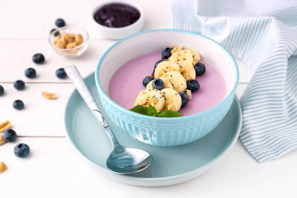 Bowl with tasty blueberry smoothie on white table — Stock Photo, Image