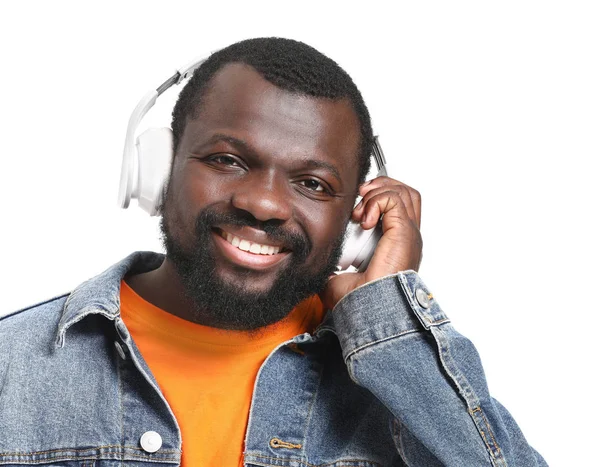 Handsome African-American man listening to music on white background — Stock Photo, Image