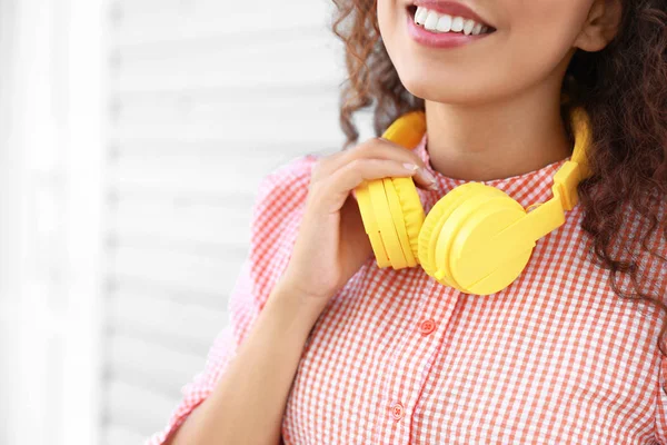 Beautiful African-American with modern headphones outdoors, closeup — Stock Photo, Image