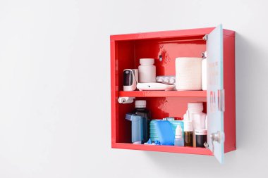 Işık arkaplanına duvar monte edilmiş ilk yardım kiti