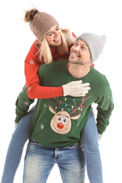 Happy couple in Christmas sweaters on white background — Stock Photo, Image