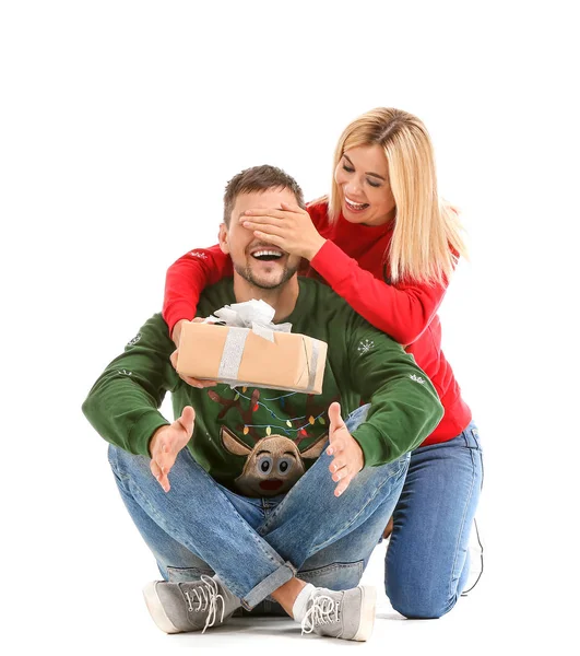 Woman giving her husband Christmas present against white background — Stock Photo, Image