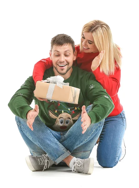 Woman giving her husband Christmas present against white background — Stock Photo, Image