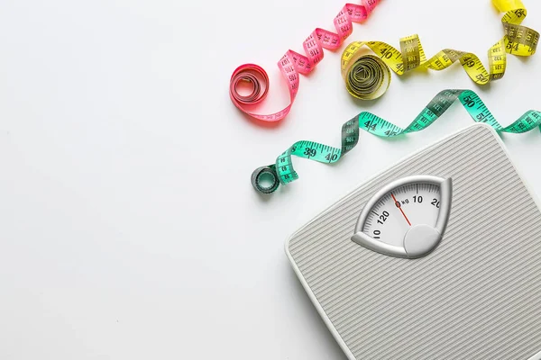 Scales and measuring tapes on white background. Weight loss concept — Stock Photo, Image