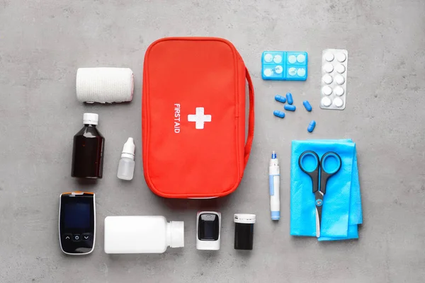 First aid kit on grey background — Stock Photo, Image