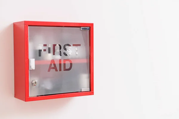Wall mounted first aid kit on light background