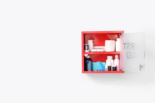 Wall mounted first aid kit on light background — Stock Photo, Image