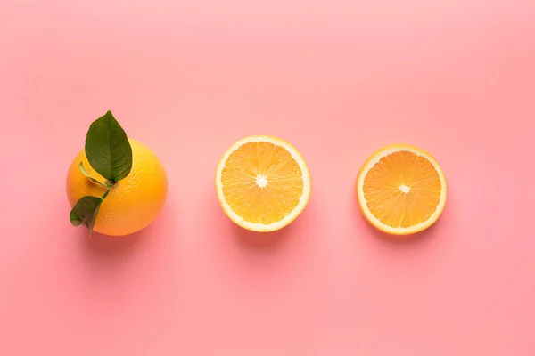 Ripe orange and slices on color background — Stock Photo, Image