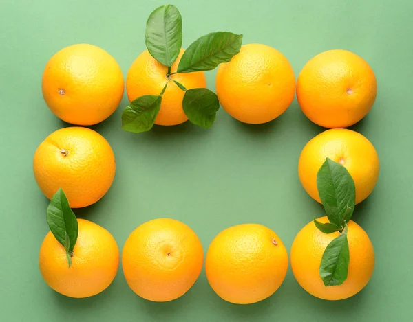 Frame made of ripe oranges on color background — Stock Photo, Image