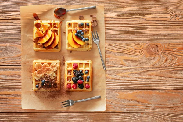 Tasty waffles with fruits and berries on wooden background — Stock Photo, Image