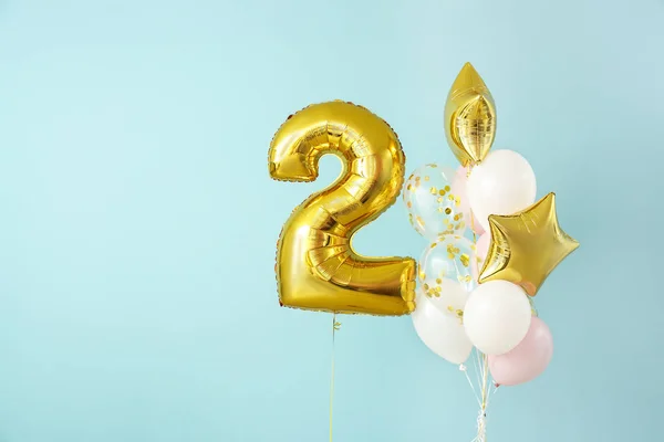 Figure 2 and different balloons on color background — Stock Photo, Image